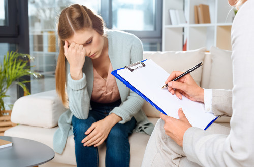 Matka z depresją po urodzeniu dziecka patrzy w obiektyw